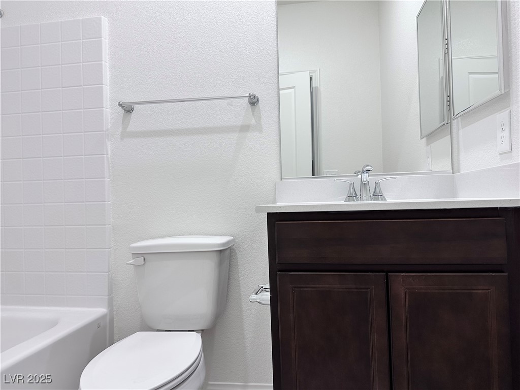 3634 Cameri Avenue Henderson, NV 89044 - Photo 6 of 22 Bathroom with a textured wall, vanity, and shower / washtub combination
