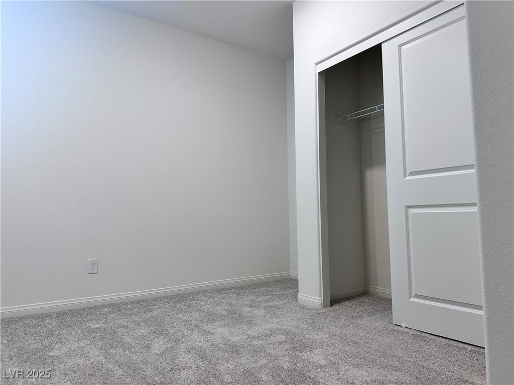 3634 Cameri Avenue Henderson, NV 89044 - Photo 7 of 22 Unfurnished bedroom with light carpet and a closet