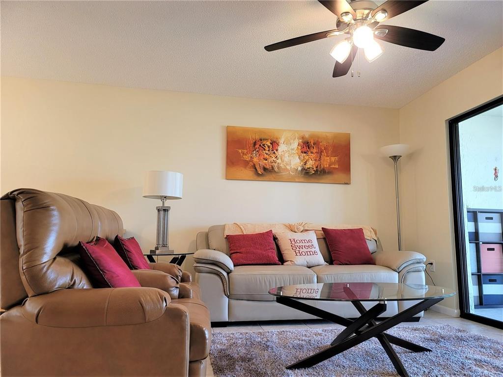 5147 Willow Links, Unit 18 Sarasota, FL 34235 - Photo 17 of 30 a living room with furniture a rug and a window