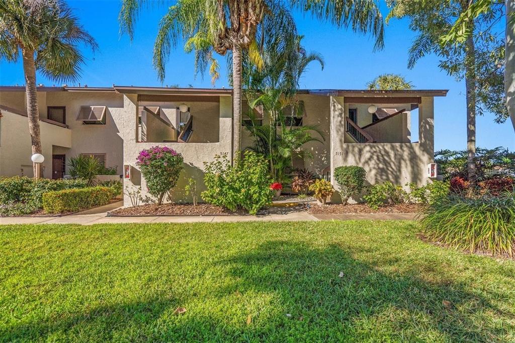 5147 Willow Links, Unit 18 Sarasota, FL 34235 - Photo 2 of 30 a front view of a house with garden