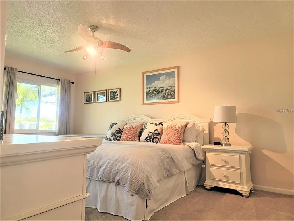 5147 Willow Links, Unit 18 Sarasota, FL 34235 - Photo 22 of 30 a bedroom with a bed and a window