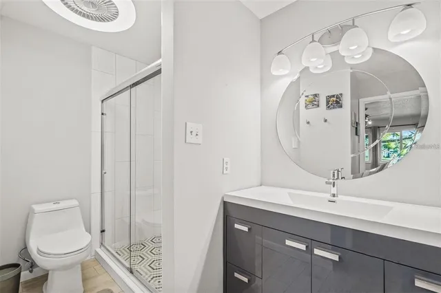 a bathroom with a sink a toilet and a mirror