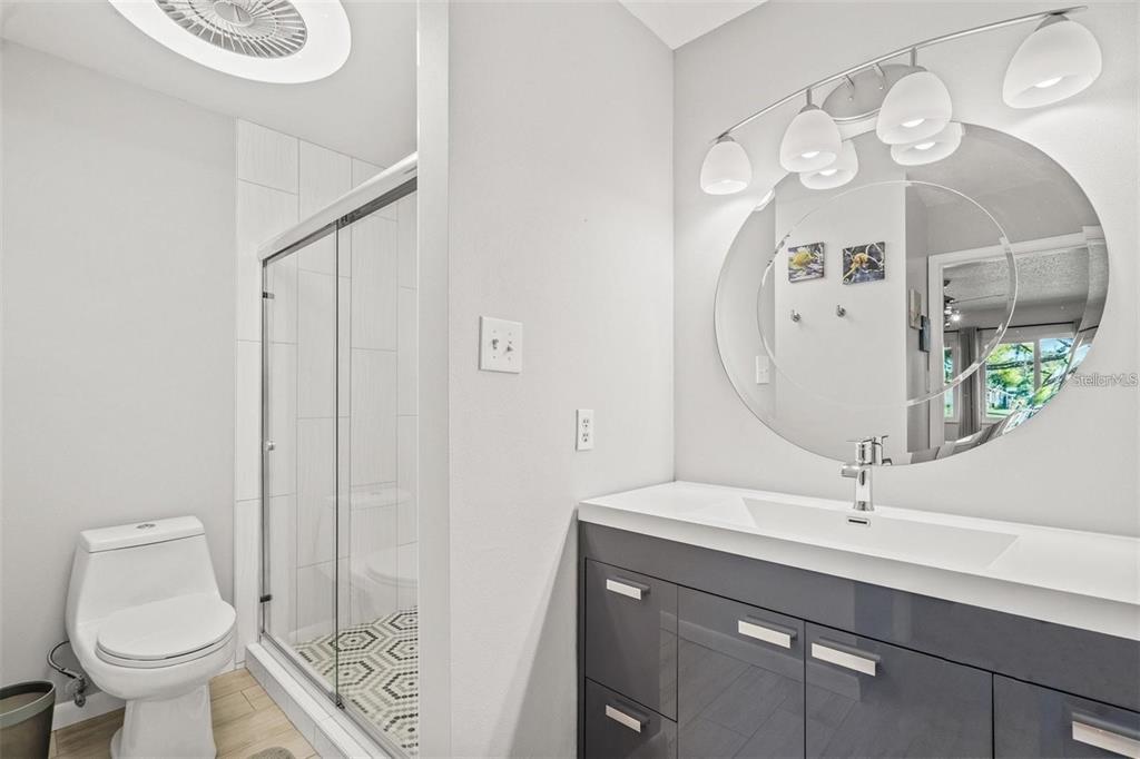 5147 Willow Links, Unit 18 Sarasota, FL 34235 - Photo 24 of 30 a bathroom with a sink a toilet and a mirror