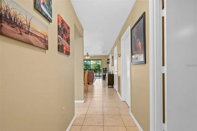 a view of a hallway with a dining table and chairs