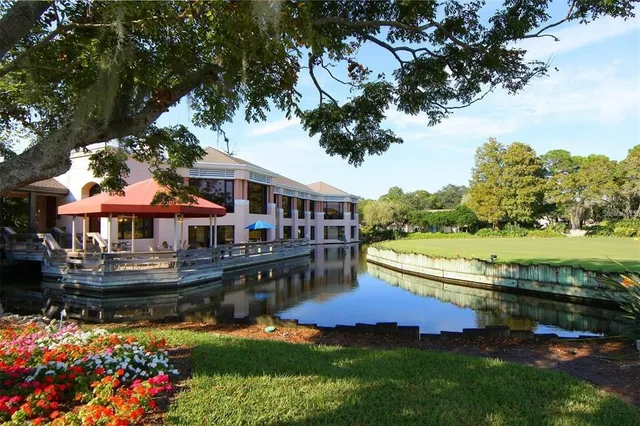 a view of a house with swimming pool and a yard