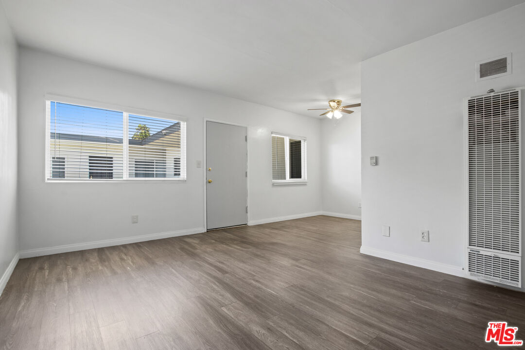 115 North Oak Street, Unit 15 Inglewood, CA 90301 - Photo 13 of 16 a view of an empty room with wooden floor and a window