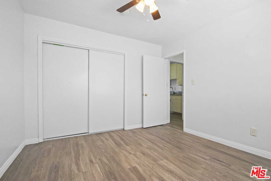 115 North Oak Street, Unit 15 Inglewood, CA 90301 - Photo 15 of 16 an empty room with wooden floor cabinet and windows