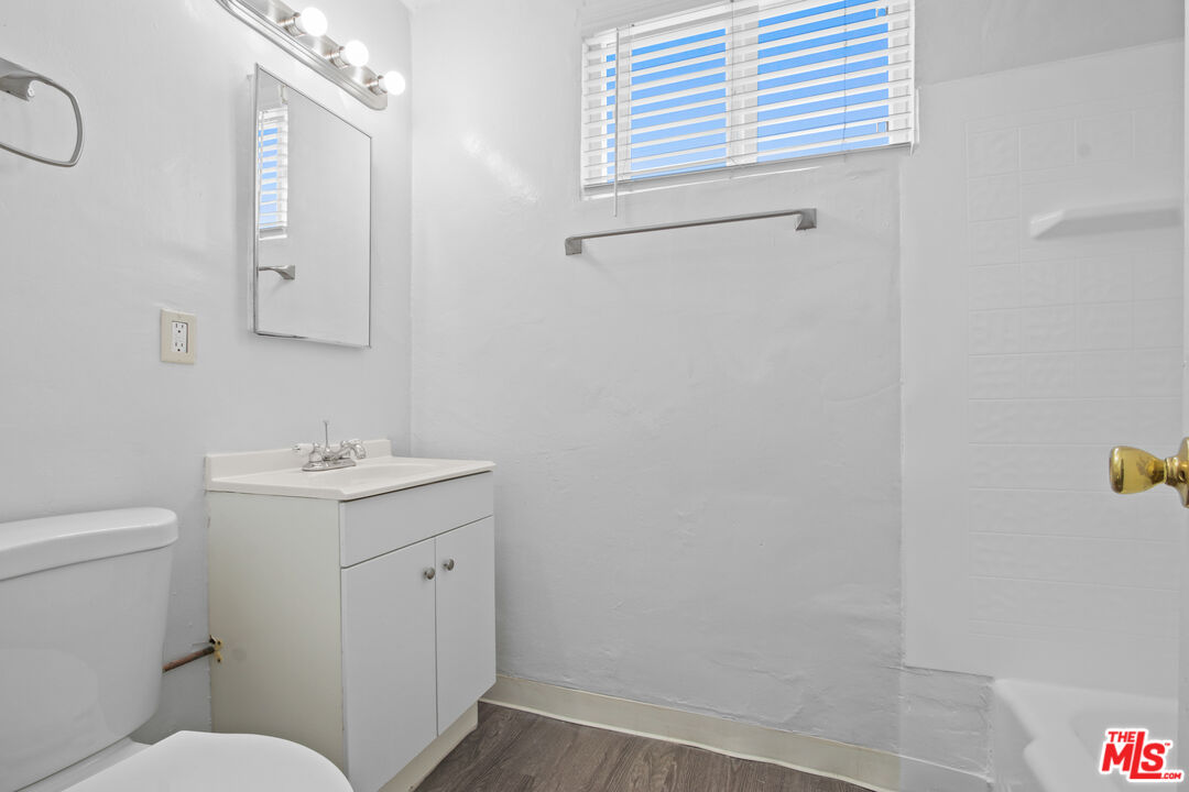 115 North Oak Street, Unit 15 Inglewood, CA 90301 - Photo 16 of 16 a bathroom with a sink toilet and vanity
