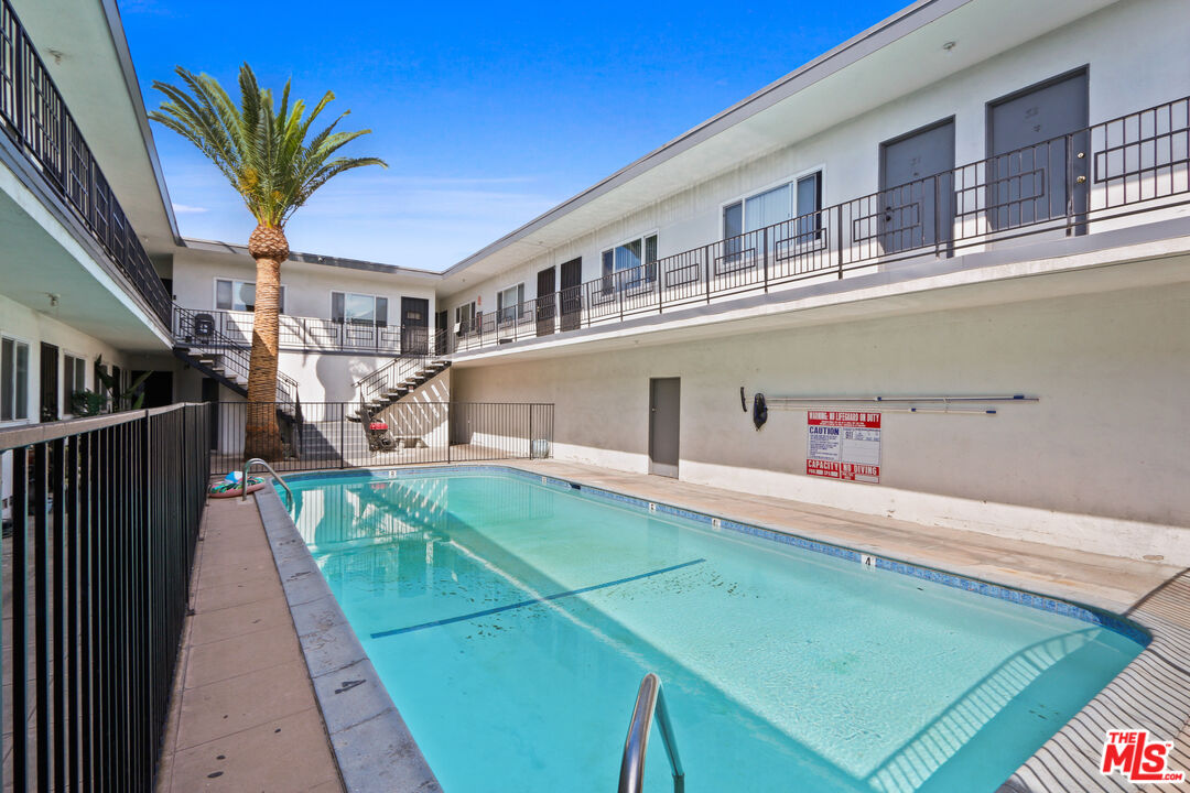 115 North Oak Street, Unit 15 Inglewood, CA 90301 - Photo 6 of 16 a view of a house with a swimming pool with a small yard