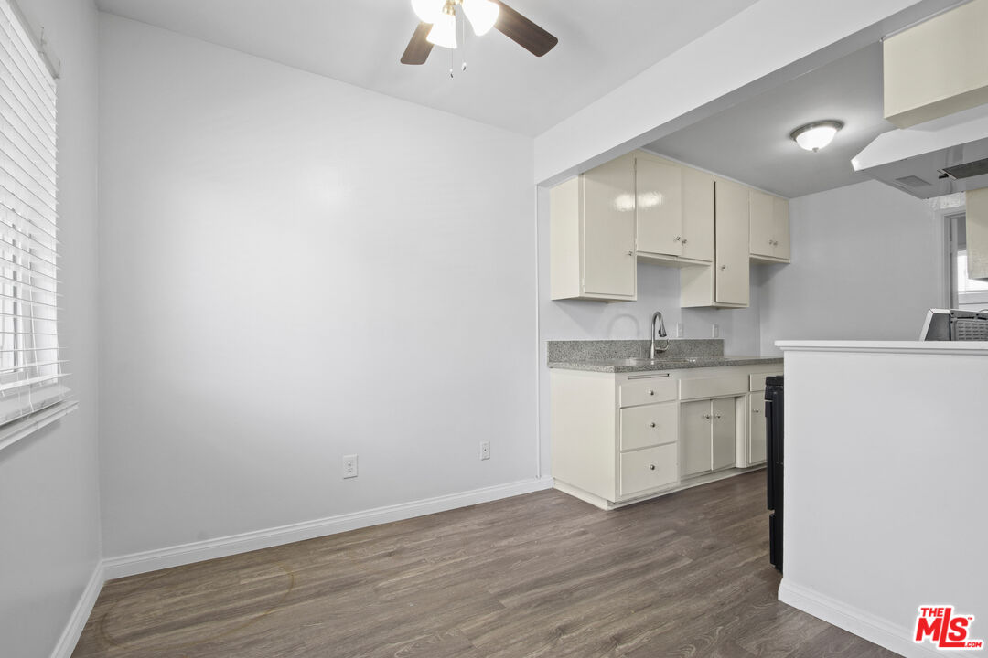 115 North Oak Street, Unit 15 Inglewood, CA 90301 - Photo 9 of 16 a room with a white cabinets and wooden floors