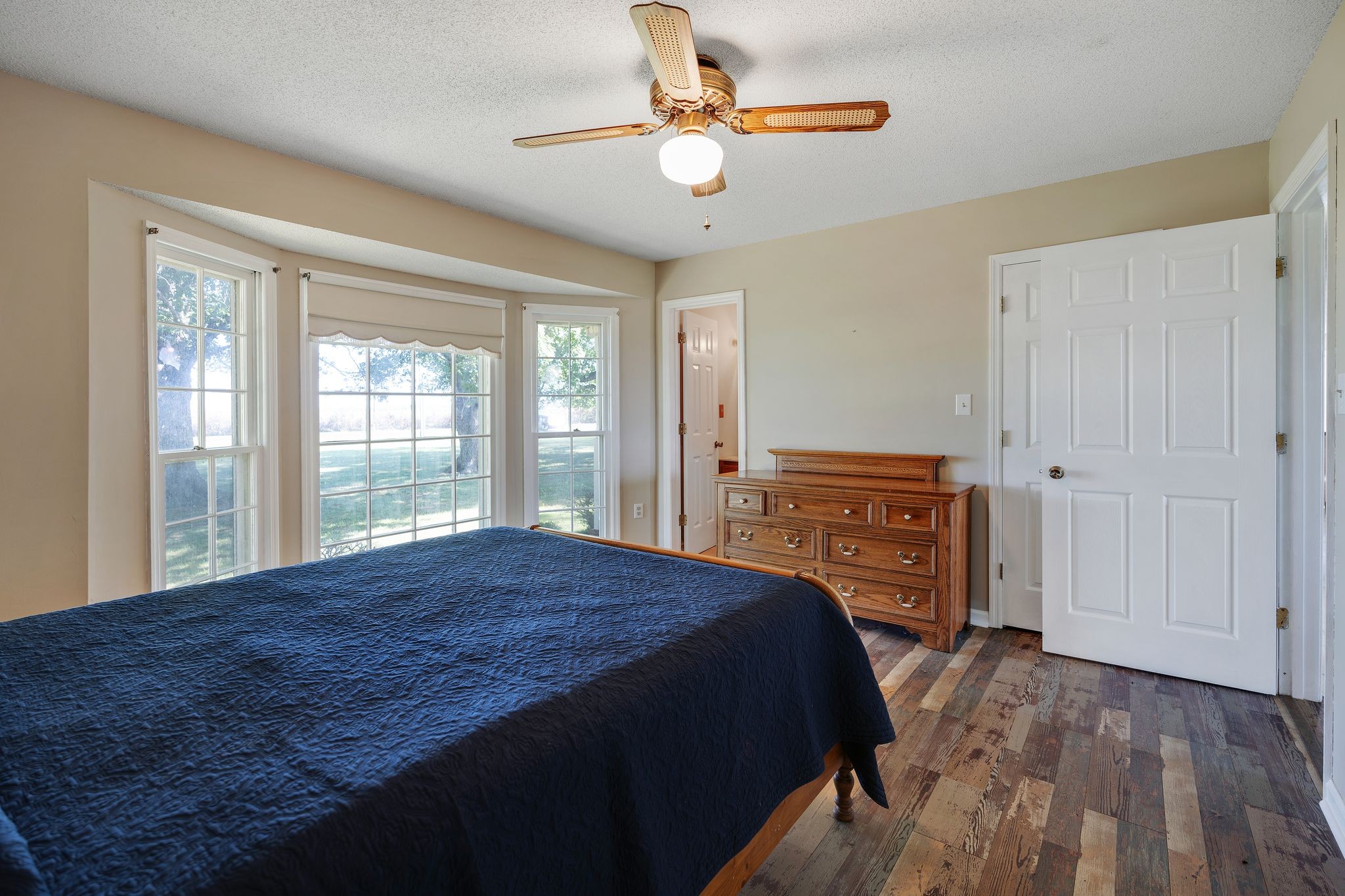 155 Marcella Falls Road Ethridge, TN 38456 - Photo 14 of 33 a bedroom with a bed a dresser and a chandelier