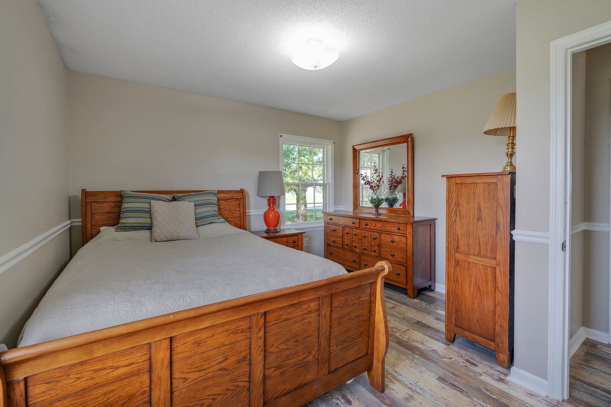 155 Marcella Falls Road Ethridge, TN 38456 - Photo 16 of 33 a bedroom with a bed and wooden floor