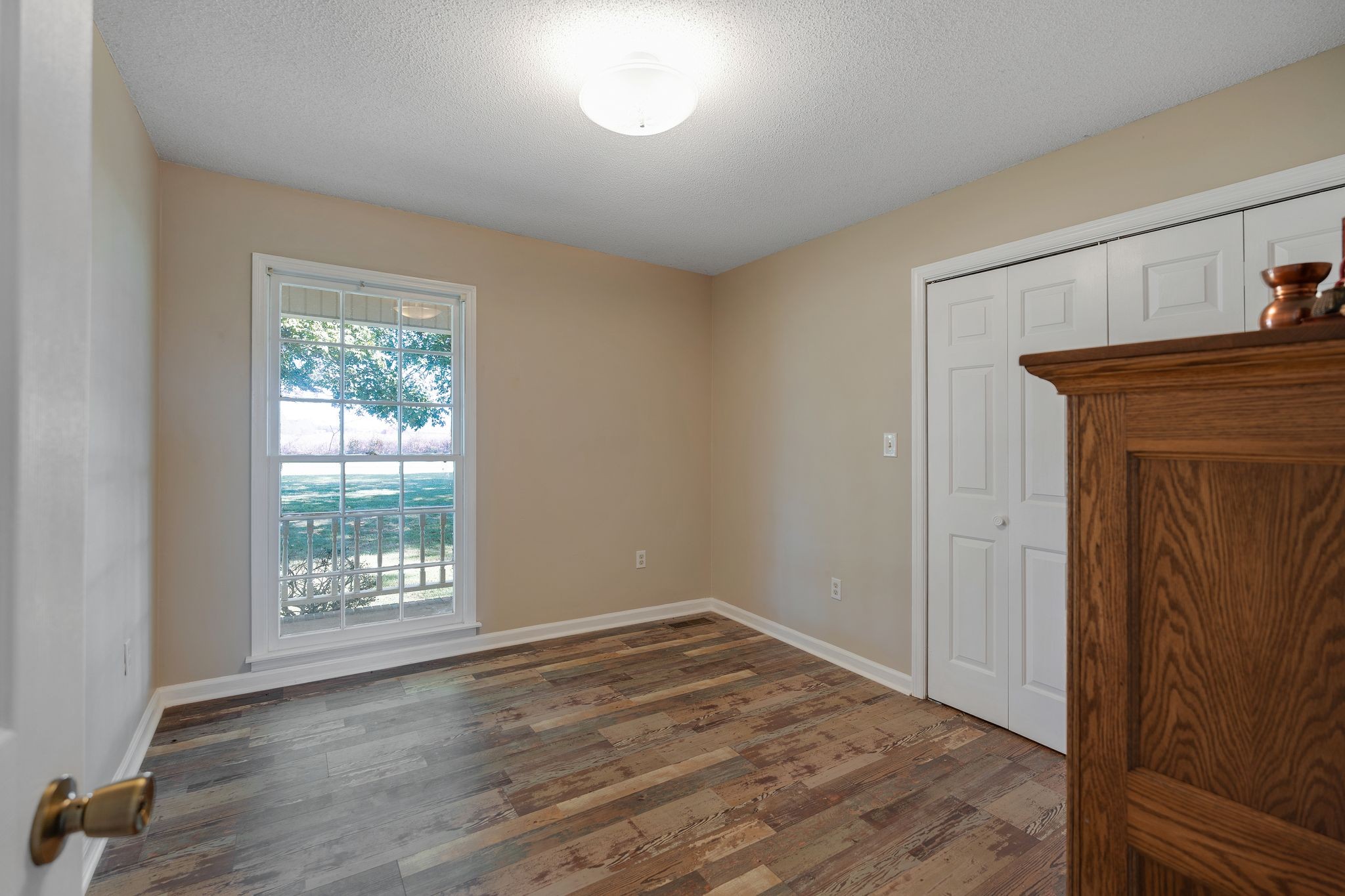 155 Marcella Falls Road Ethridge, TN 38456 - Photo 18 of 33 an empty room with wooden floor cabinet and windows