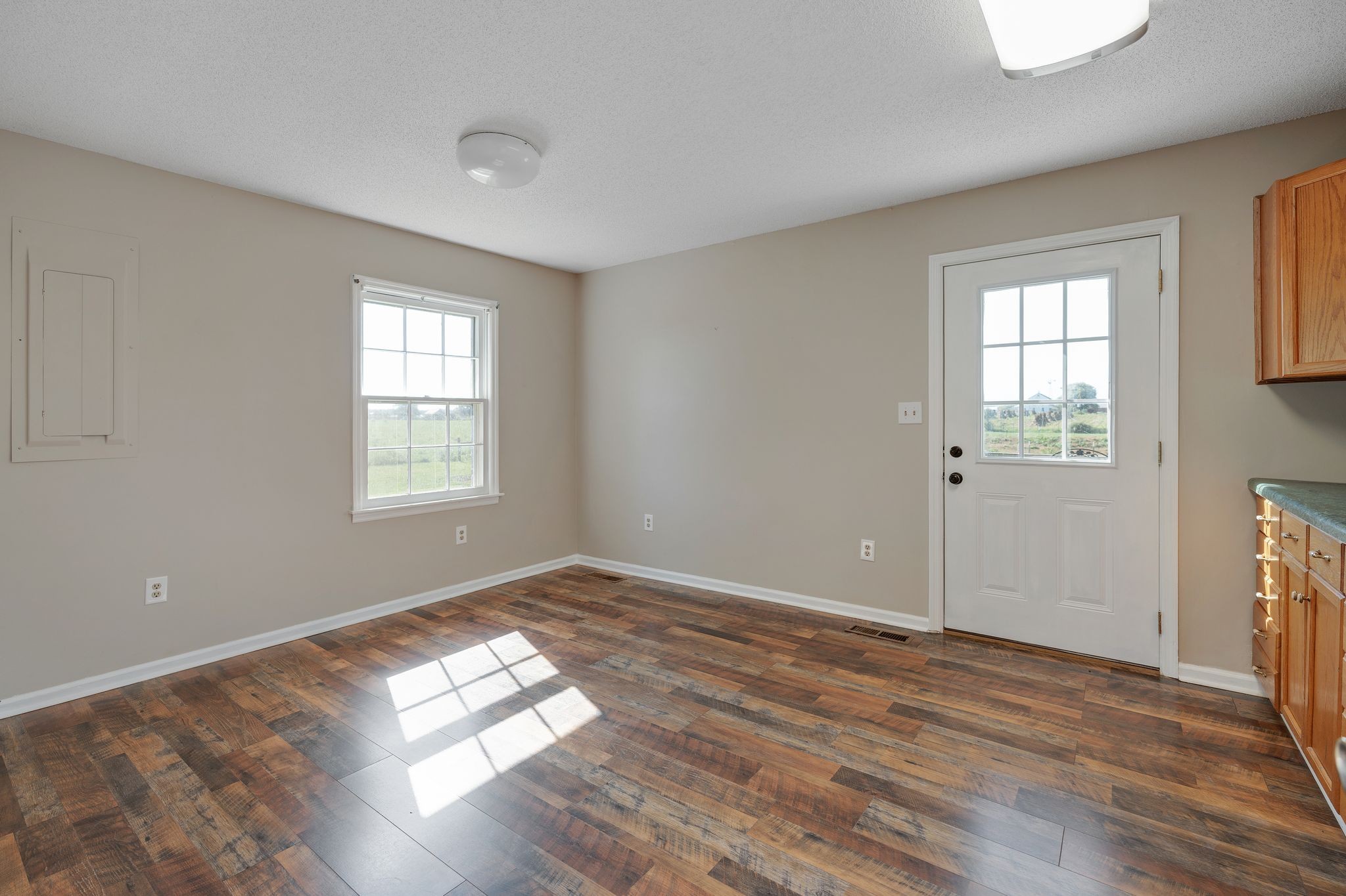155 Marcella Falls Road Ethridge, TN 38456 - Photo 23 of 33 an empty room with wooden floor and windows