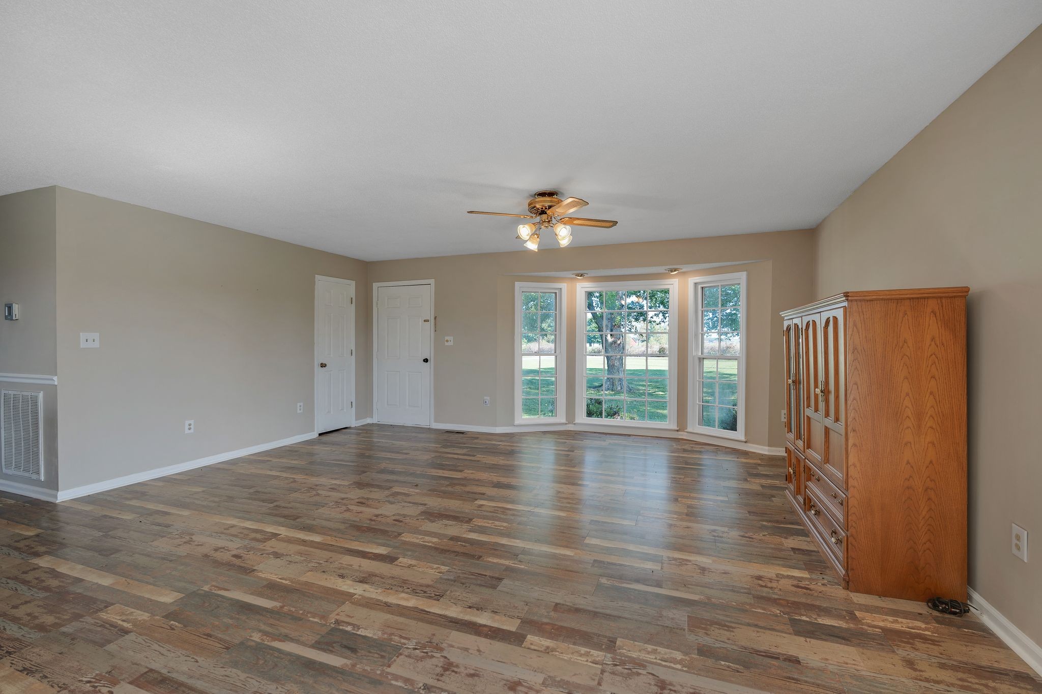 155 Marcella Falls Road Ethridge, TN 38456 - Photo 6 of 33 a view of an empty room with wooden floor and a window