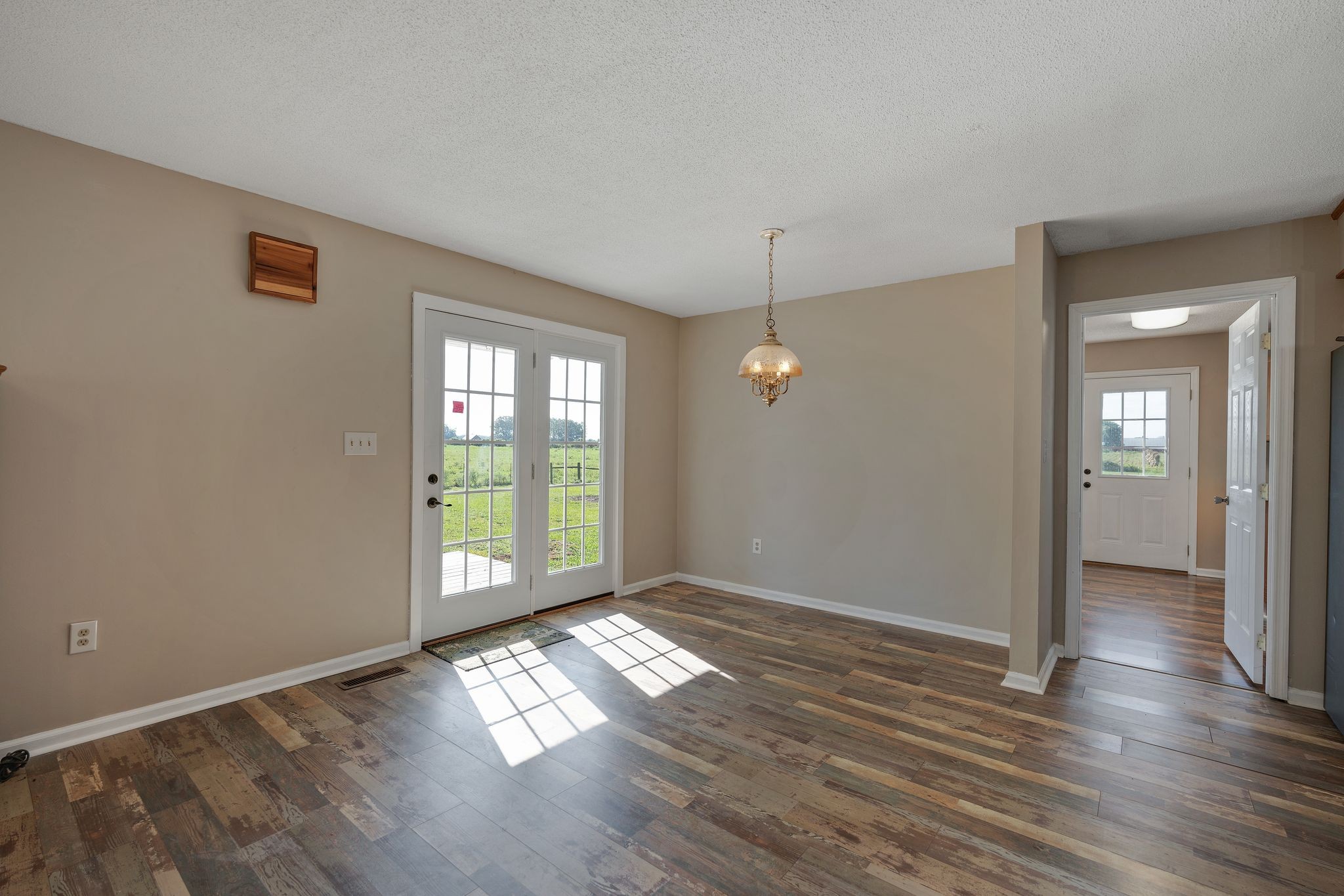155 Marcella Falls Road Ethridge, TN 38456 - Photo 8 of 33 an empty room with wooden floor and windows