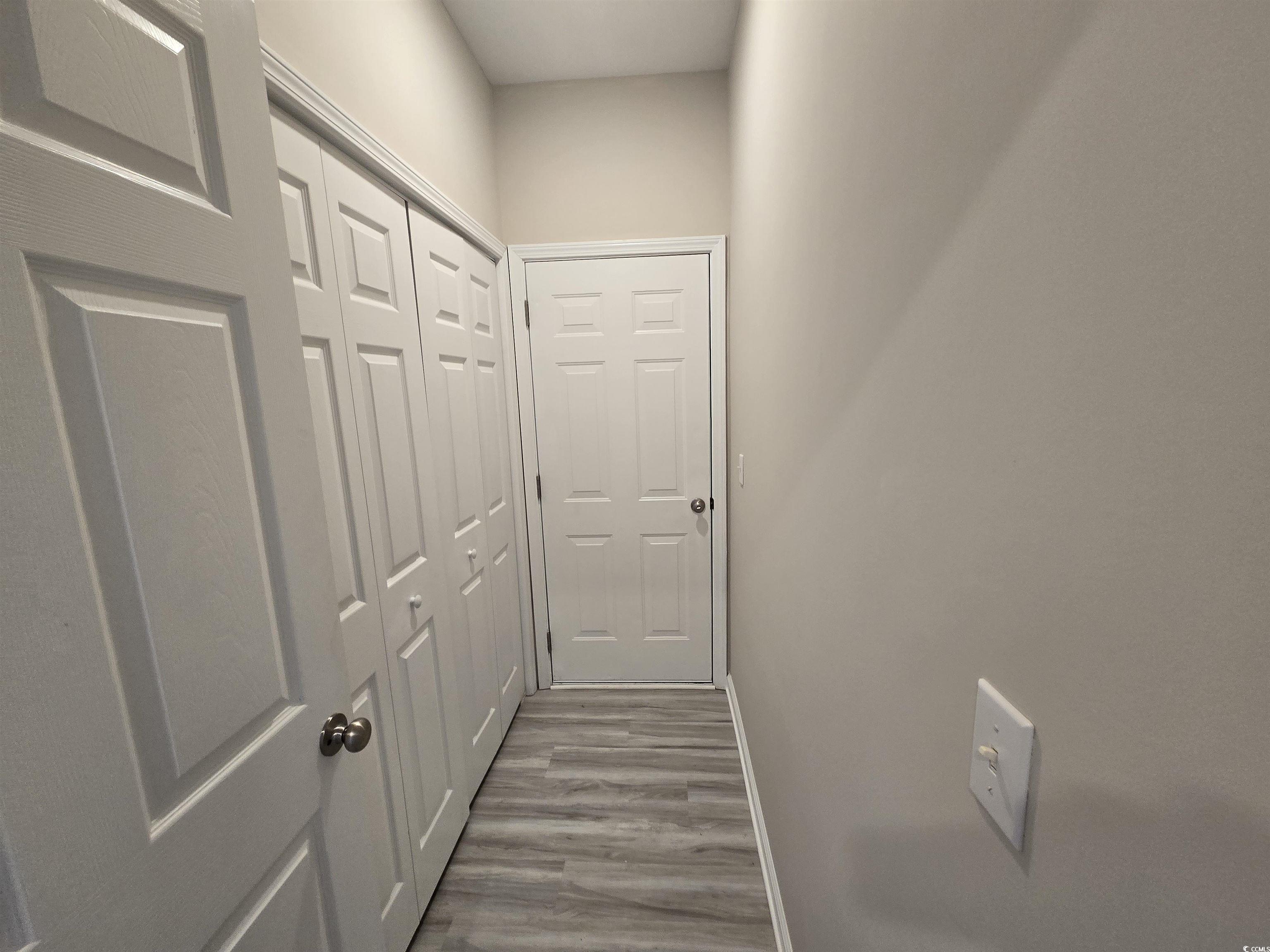 129 Powder Springs Loop Myrtle Beach, SC 29588 - Photo 18 of 23 Hallway with wood finished floors and baseboards
