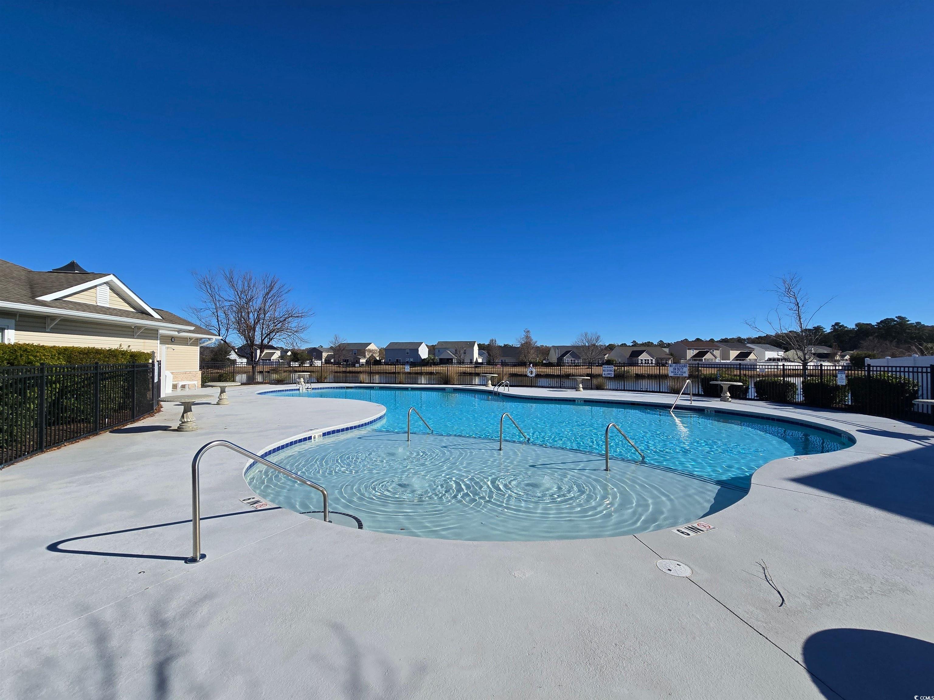 129 Powder Springs Loop Myrtle Beach, SC 29588 - Photo 22 of 23 Community pool featuring a patio and a residential view