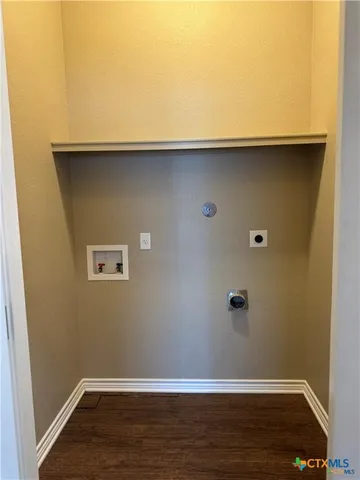 an empty room with wooden floor chandelier fan and windows