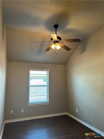 a view of a hallway with wooden floor and closet area