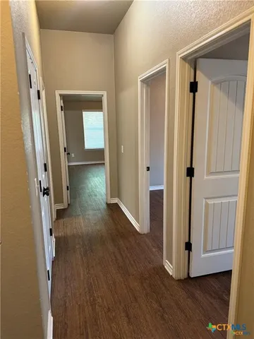 a kitchen with granite countertop a refrigerator stove and sink