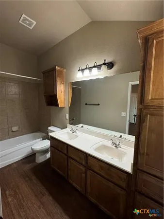 a bathroom with a double vanity sink and a mirror