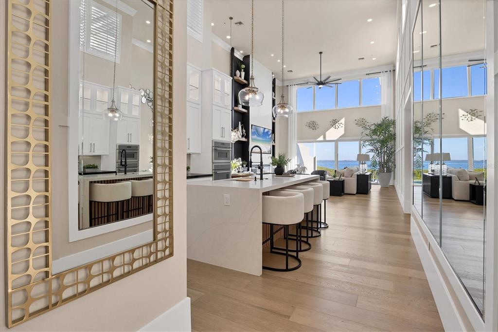 3540 Mistletoe Lane Longboat Key, FL 34228 - Photo 16 of 80 a kitchen with stainless steel appliances kitchen island granite countertop a refrigerator a stove a sink and white cabinets with wooden floor