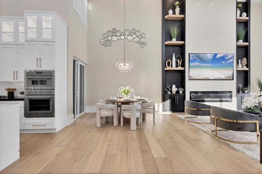 3540 Mistletoe Lane Longboat Key, FL 34228 - Photo 24 of 80 a view of a dining room with furniture a chandelier and wooden floor