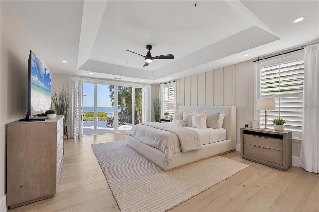 3540 Mistletoe Lane Longboat Key, FL 34228 - Photo 26 of 80 a spacious bedroom with a large bed and a flat screen tv