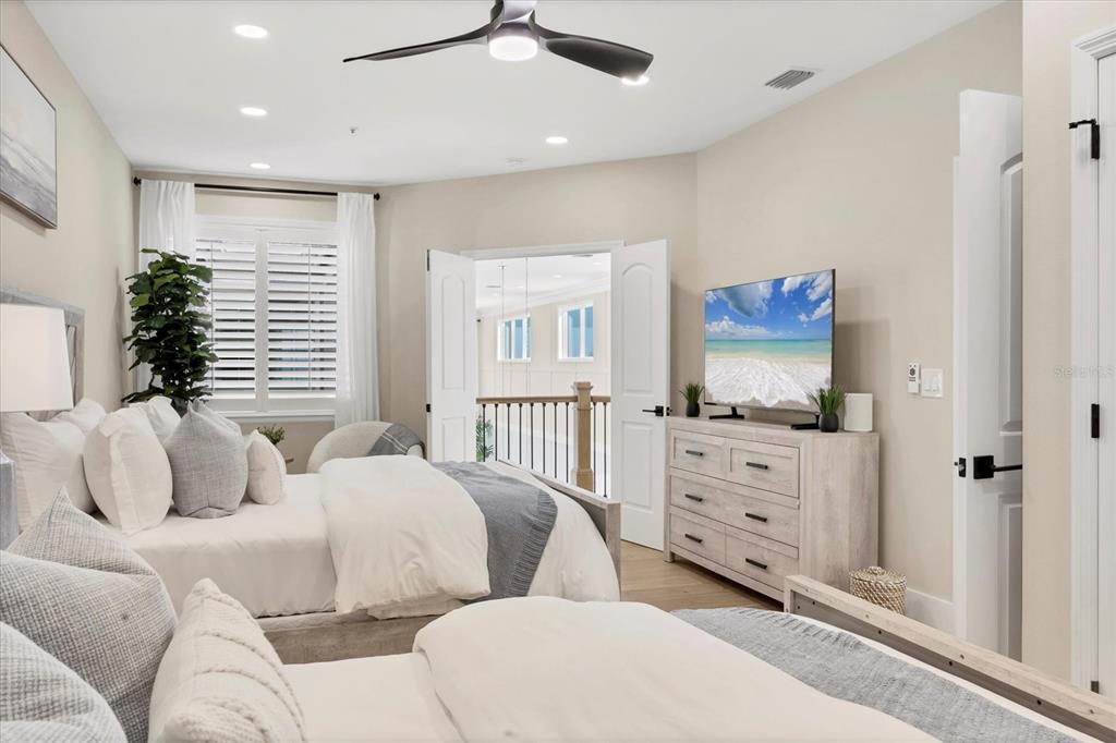 3540 Mistletoe Lane Longboat Key, FL 34228 - Photo 31 of 80 a bedroom with furniture and a flat screen tv