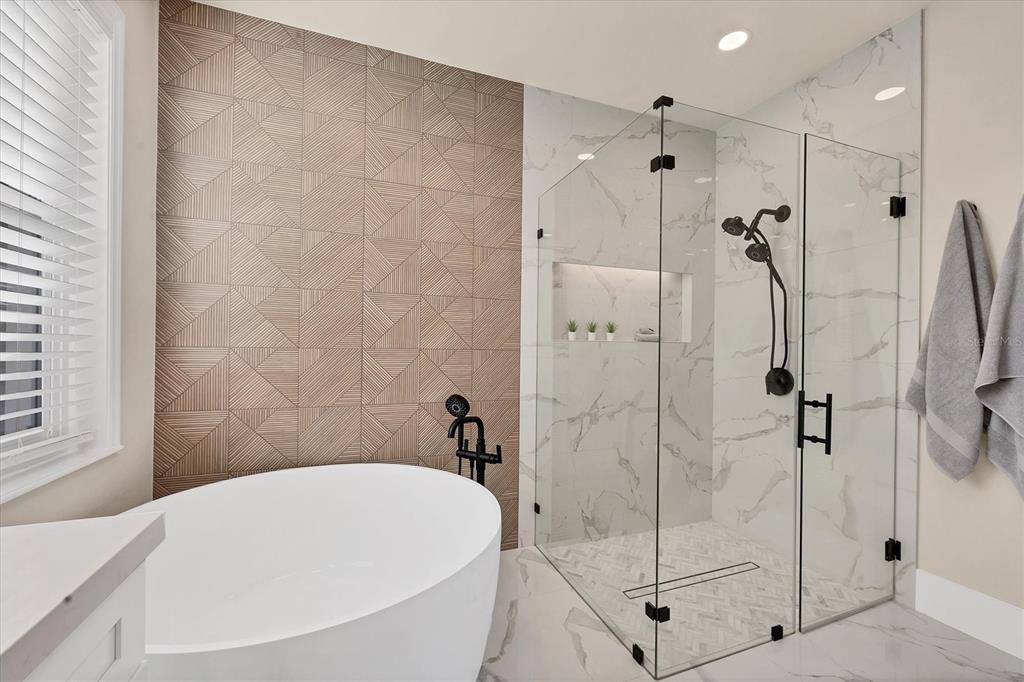 3540 Mistletoe Lane Longboat Key, FL 34228 - Photo 32 of 80 a bathroom with a white bath tub and a shower