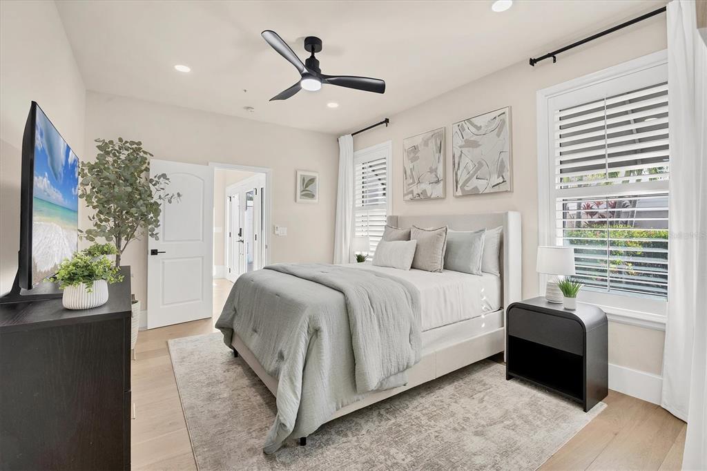 3540 Mistletoe Lane Longboat Key, FL 34228 - Photo 35 of 80 a spacious bedroom with a bed and a chandelier