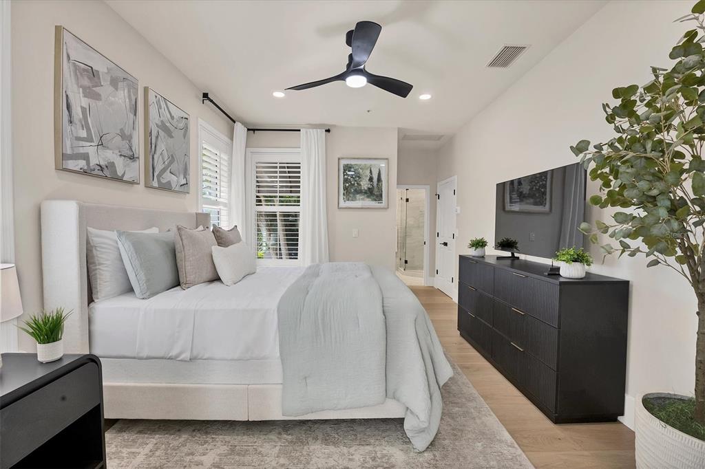 3540 Mistletoe Lane Longboat Key, FL 34228 - Photo 36 of 80 a spacious bedroom with a bed and a chandelier