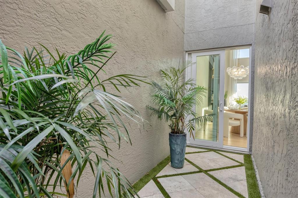 3540 Mistletoe Lane Longboat Key, FL 34228 - Photo 41 of 80 a potted plant sitting in front of a glass door