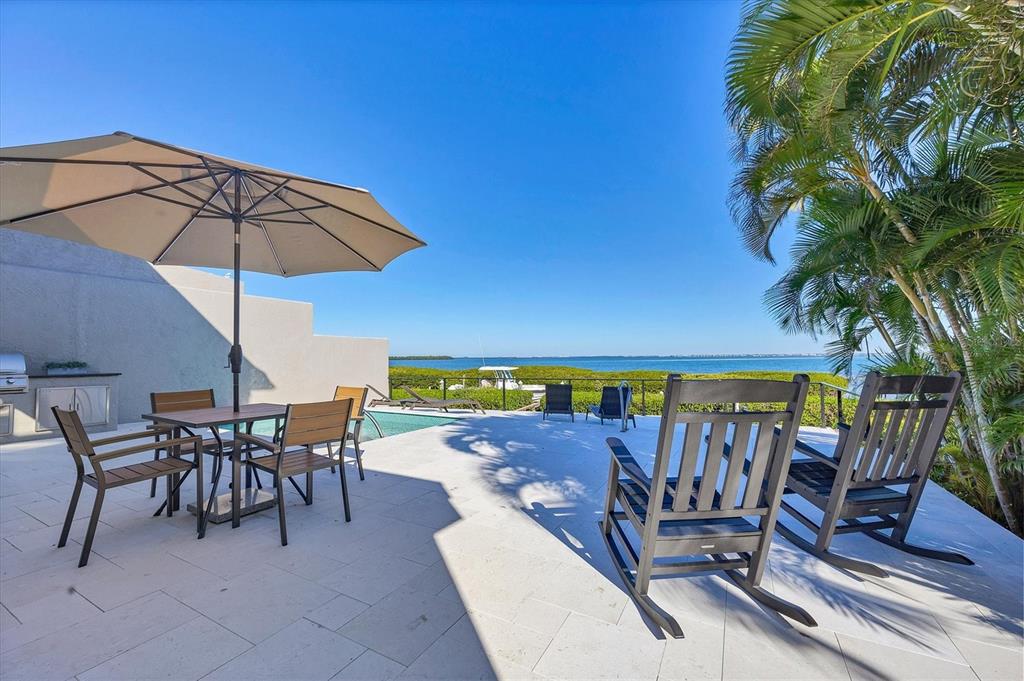 3540 Mistletoe Lane Longboat Key, FL 34228 - Photo 47 of 80 a view of a chairs and table in patio