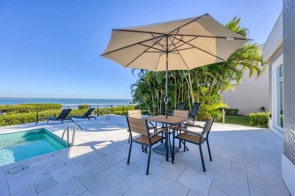 3540 Mistletoe Lane Longboat Key, FL 34228 - Photo 48 of 80 a patio with a patio table and chairs