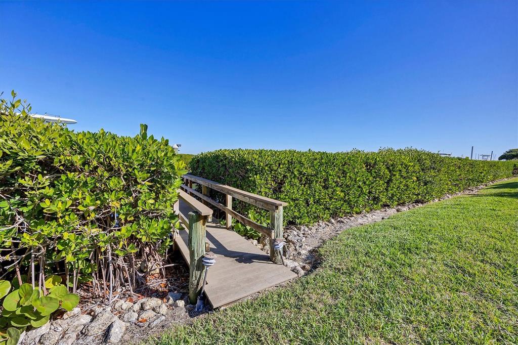 3540 Mistletoe Lane Longboat Key, FL 34228 - Photo 53 of 80 a view of a chairs and table on the green field