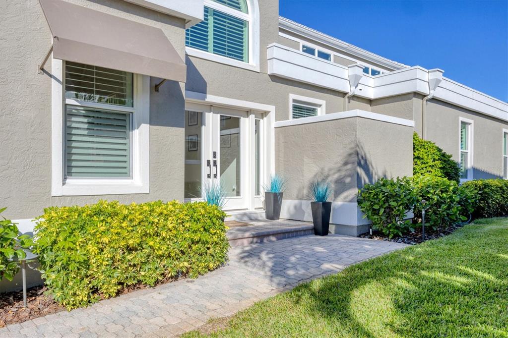 3540 Mistletoe Lane Longboat Key, FL 34228 - Photo 80 of 80 a view of a house with potted plants next to a road