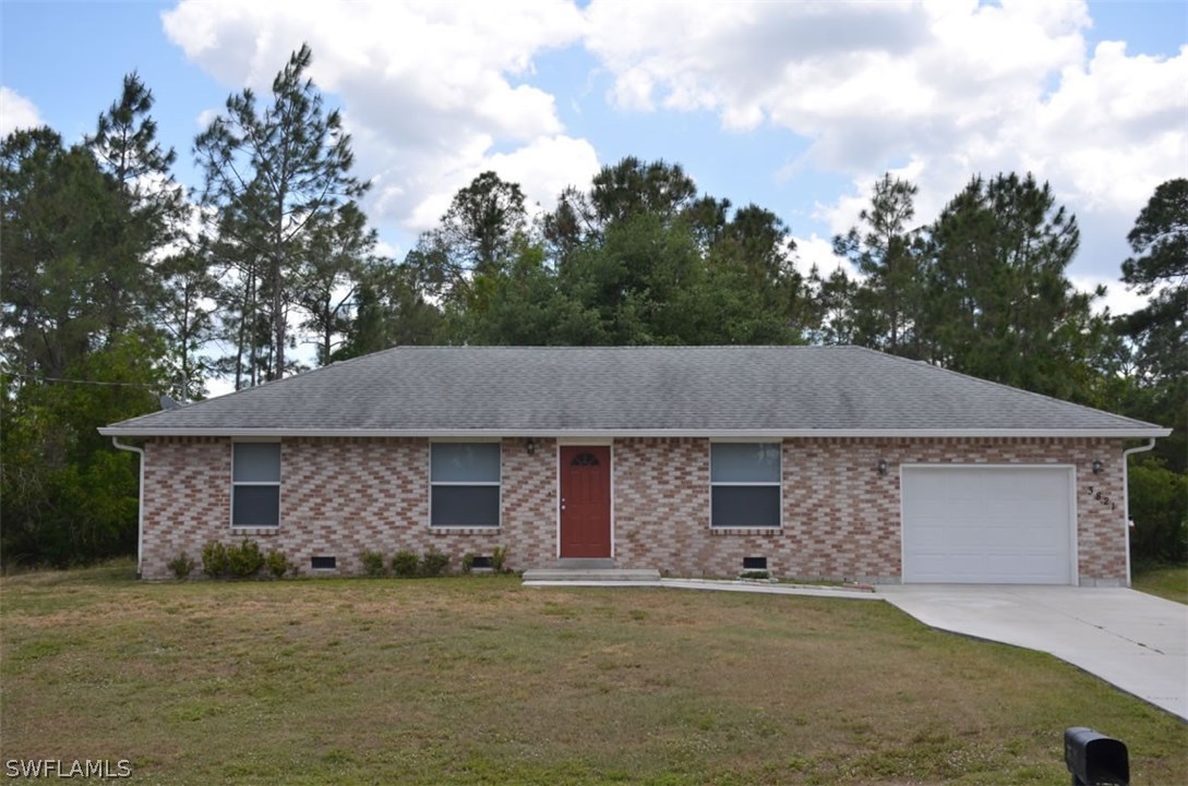 3821 Sunset Road Lehigh Acres, FL 33971 - Photo 2 of 20 front view of a house with a yard