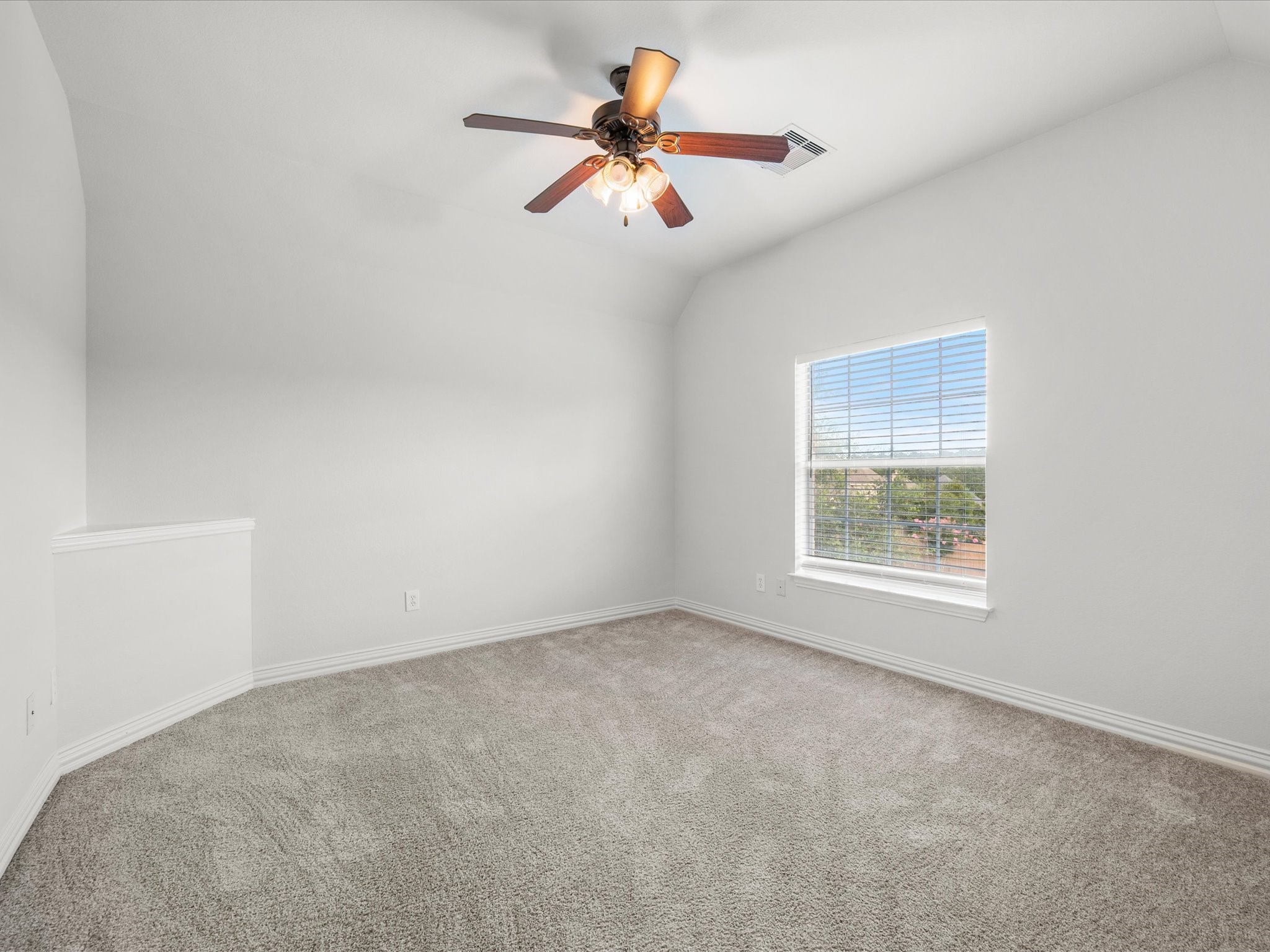 323 Arbor Ridge Lane Conroe, TX 77384 - Photo 28 of 40 Soft carpet, vaulted ceiling, and a window framing the treetops. Quiet corner of the house that works for guests, kids, or a craft room you've been dreaming about.