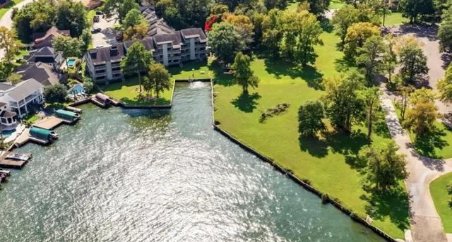 an aerial view of a house with a yard and lake view
