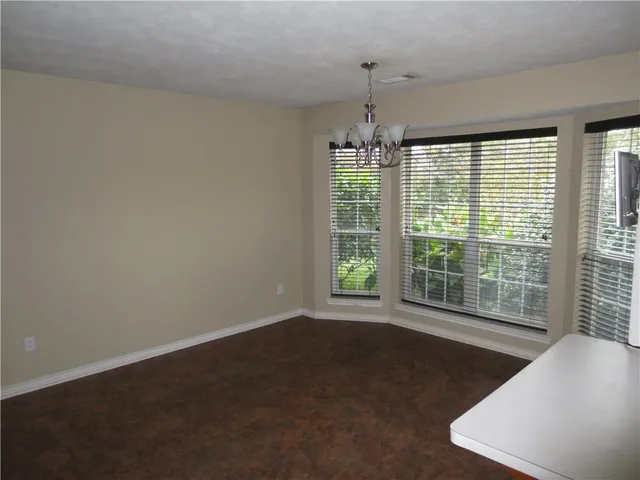 a view of a livingroom with a ceiling fan and window