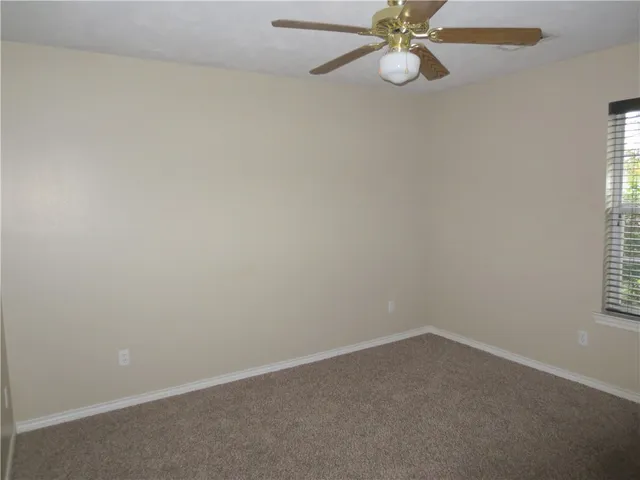 en empty room with window and fan