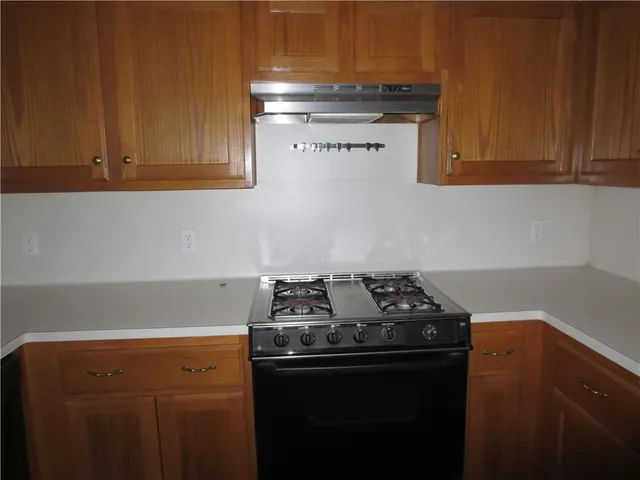 a kitchen with a stove and a cabinets