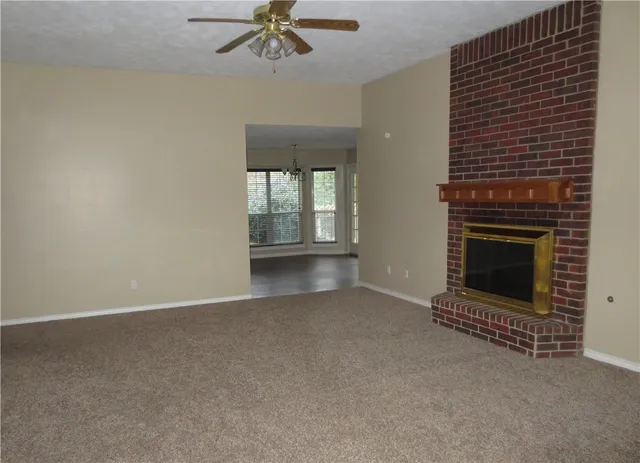 a view of an empty room with a fireplace