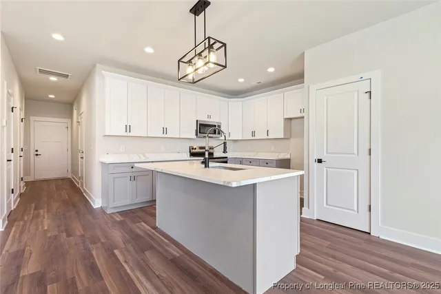 a kitchen with a sink stainless steel appliances and cabinets