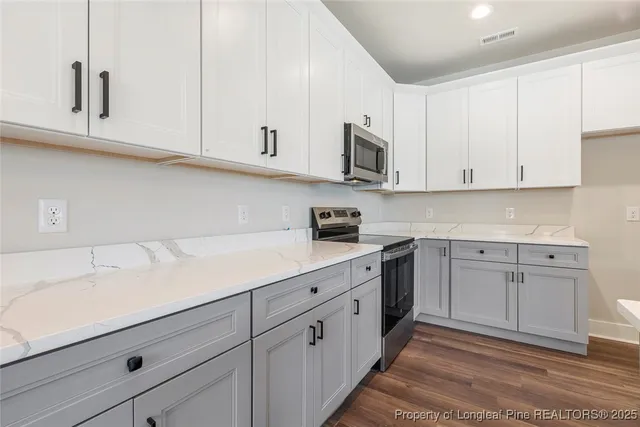 a kitchen with white cabinets and white appliances