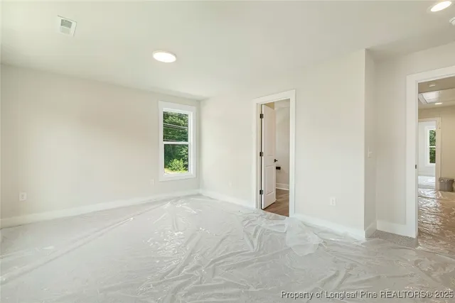 an empty room with windows and closet