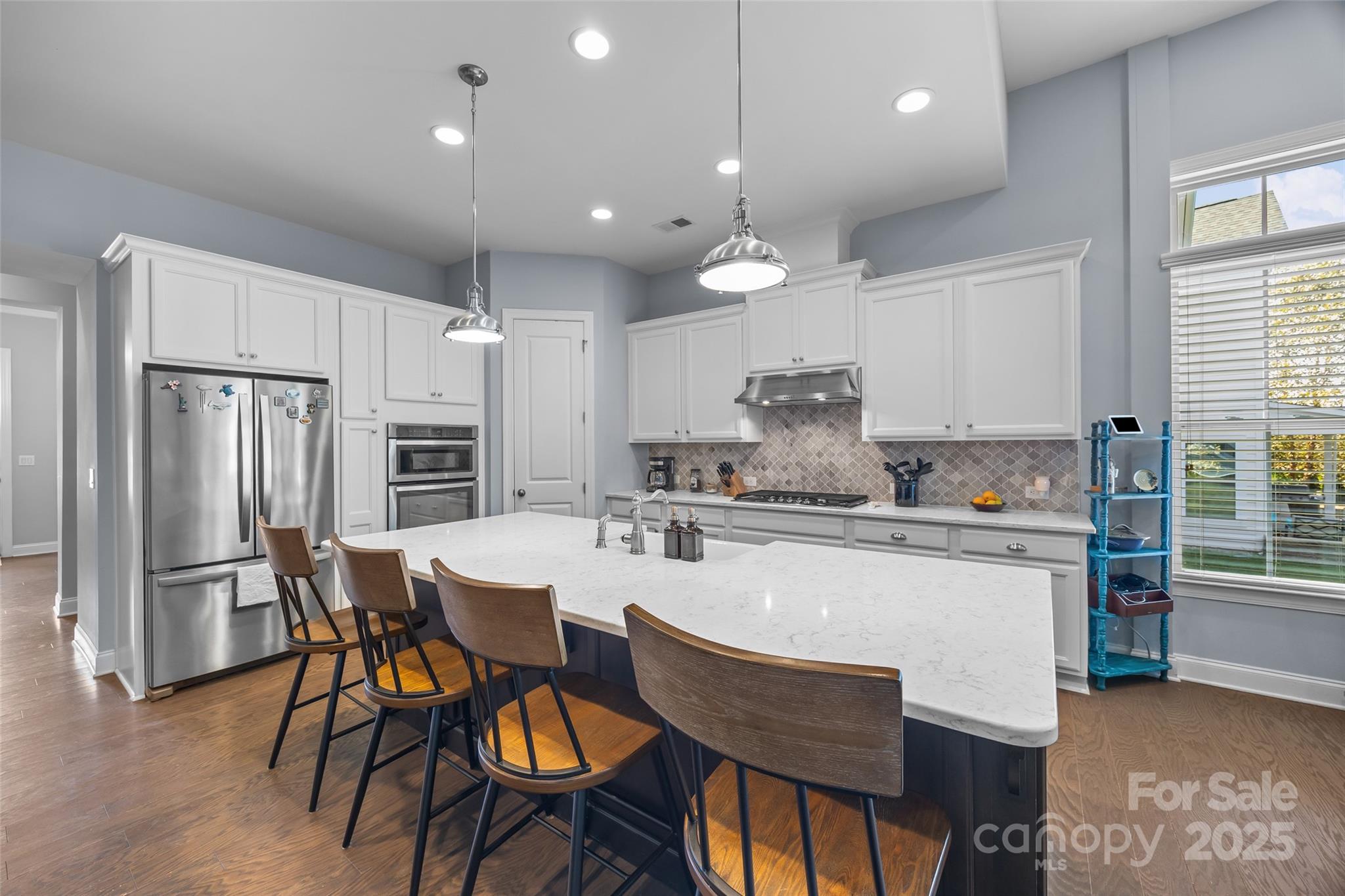 5212 Meadowcroft Way Fort Mill, SC 29708 - Photo 7 of 43 a kitchen with stainless steel appliances kitchen island granite countertop a dining table chairs and a refrigerator