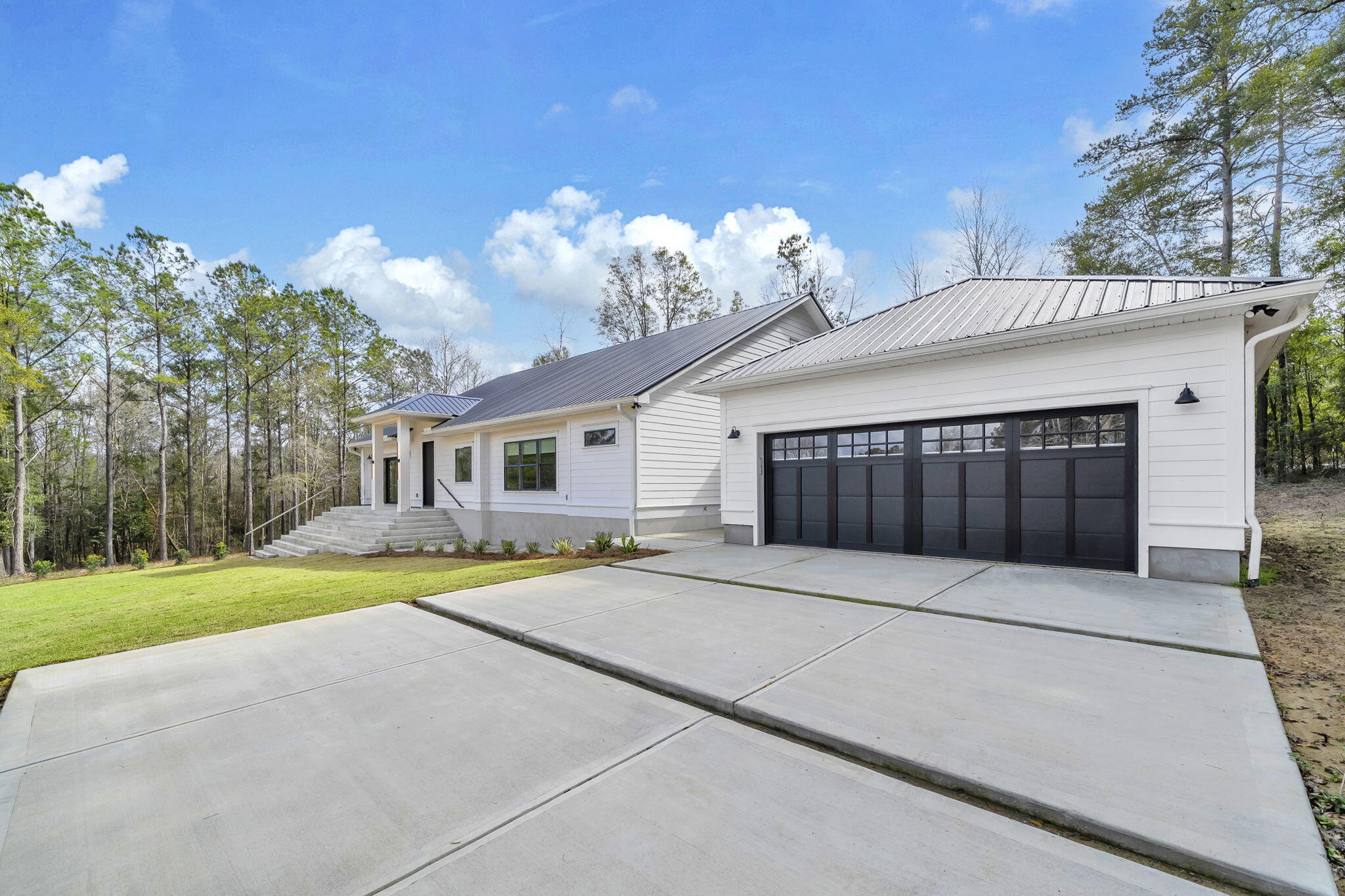 1388 Pusley Hill Road Ponce de Leon, FL 32455 - Photo 11 of 16 a front view of a house with a yard and garage